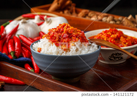 steamed white rice topped with spicy Hunan chopped chili pepper sauce in bowl. 141121172