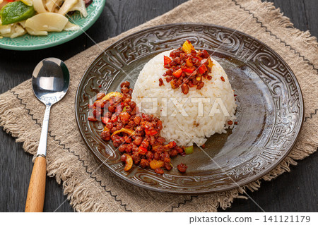 steamed white rice served with savory fermented black bean chili sauce on a rustic plate. 141121179