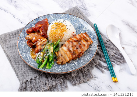 braised pork feet and sliced pork belly combo rice with green vegetables on a decorative plate. braised pork feet and sliced pork belly combo rice with green vegetables on a decorative plate. 141121215