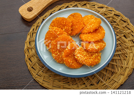 crispy deep-fried Chinese pumpkin cakes, golden sweet pumpkin patties on a plate. crispy deep-fried Chinese pumpkin cakes, golden sweet pumpkin patties on a plate. 141121218