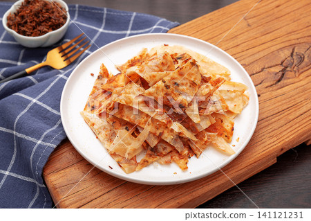 sliced crunchy Chinese Guokuei flatbread served with chili oil sauce, traditional Asian street food. sliced crunchy Chinese Guokuei flatbread served with chili oil sauce, traditional Asian street food. 141121231