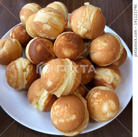 Homemade baby castella cakes piled high on a plate 141121746