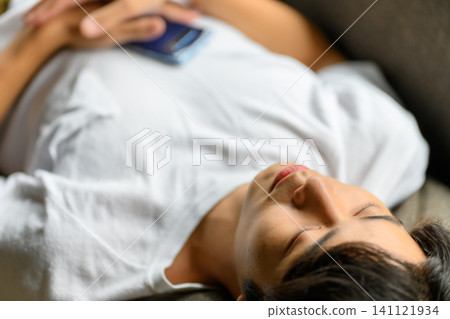 Man sleeping on the couch Man sleeping on the couch 141121934