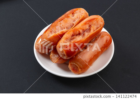 grilled Taiwanese Style Premium Pork Sausages on Plate with Wooden Board 141122474