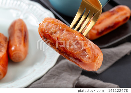 close-up of Juicy Grilled Pork Sausage on Gold Fork close-up of Juicy Grilled Pork Sausage on Gold Fork 141122478