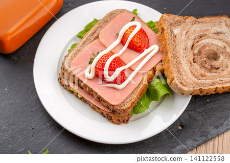 homemade sandwich with sliced ham, fresh strawberry, lettuce and mayonnaise homemade sandwich with sliced ham, fresh strawberry, lettuce and mayonnaise 141122558