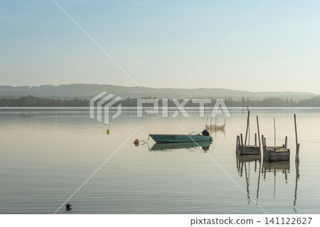 Fishing boat and fish traps on Lake Constance, Germany Fishing boat and fish traps on Lake Constance, Germany 141122627