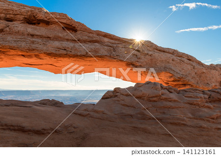 Breathtaking sunrise illuminates majestic rock arch formation in vast desert landscape of Canyonlands National Park, Utah, USA, evoking sense of wonder and natural beauty Breathtaking sunrise illuminates majestic rock arch formation in vast desert landscape of Canyonlands National Park, Utah, USA, evoking sense of wonder and natural beauty 141123161