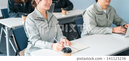 Businessmen and women in work clothes listening to a conference, meeting, or presentation 141123236