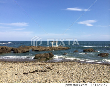 A rocky coastline under a clear blue sky. A rocky coastline under a clear blue sky. 141123347
