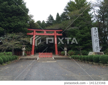 A red torii gate and shrine entrance surrounded by a forest. A red torii gate and shrine entrance surrounded by a forest. 141123348