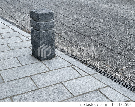Stone bollards on city sidewalks Stone bollards on city sidewalks 141123595
