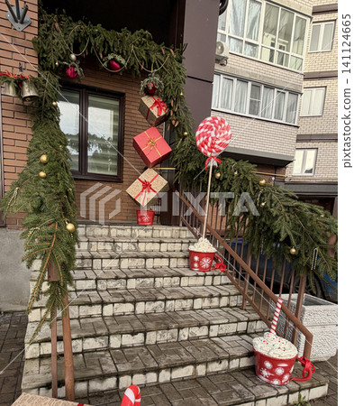 Christmas porch decoration with pine garland and hanging gift boxes, festive entrance design for New Year holidays. Christmas porch decoration with pine garland and hanging gift boxes, festive entrance design for New Year holidays. 141124665