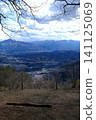 A breathtaking view of a sea of clouds and mountains, with bare trees standing out against the scenery. 141125069