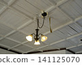 Old chandelier lighting on a white ceiling 141125070