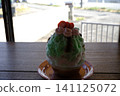 A green fruitcake topped with raspberries. 141125072