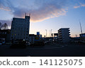 The sunset sky and the high-rise buildings in front of the station 141125075