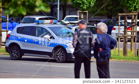 Warsaw, Poland. 6 July 2026. Policeman on a street in police car. Police sign. Warsaw, Poland. 6 July 2026. Policeman on a street in police car. Police sign. 141125523