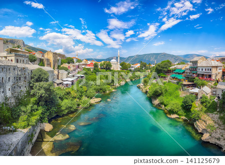 Awesome Nerteva River and Old City of Mostar, with Ottoman Mosque during sunny day Awesome Nerteva River and Old City of Mostar, with Ottoman Mosque during sunny day 141125679