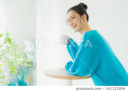 A woman drinking coffee A woman drinking coffee 141125804