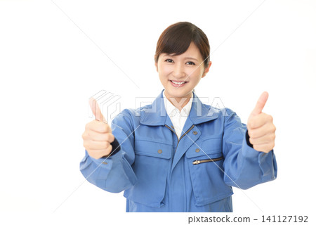 Female worker giving a thumbs-up Female worker giving a thumbs-up 141127192