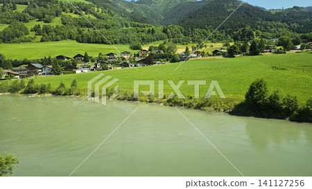 green grass field and mountain with lake green grass field and mountain with lake 141127256