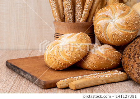 Fresh crispbread. Bread background. Different breed on wooden background. Fresh crispbread. Bread background. Different breed on wooden background. 141127381