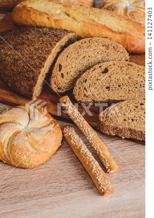 Fresh crispbread. Bread background. Different breed on wooden background. Fresh crispbread. Bread background. Different breed on wooden background. 141127403
