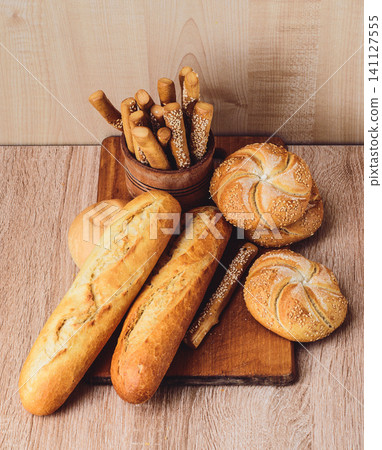 French baguettes. Fresh crispbread. Bread background. Different breed  on wooden background. 141127555