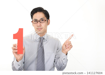 A man giving instructions while holding numbers A man giving instructions while holding numbers 141127604