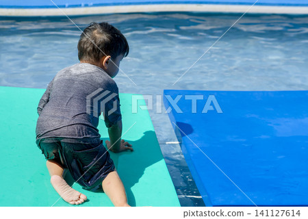 asian boy at the pool asian boy at the pool 141127614