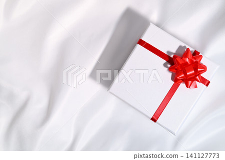 gift box with red ribbon 141127773