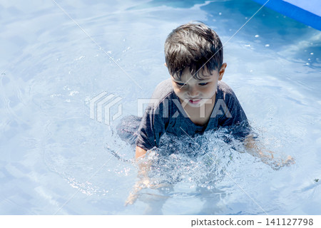 asian boy swimming in the pool asian boy swimming in the pool 141127798