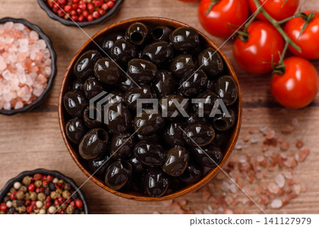 Black canned olives without pits for salads and snacks. Black olives without pits Black canned olives without pits for salads and snacks. Black olives without pits 141127979