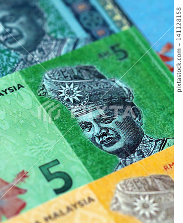 Malaysian ringgit paper banknotes pile on table. Malaysia MYR currency money bills in big amount. Concept of economics, taxation and banking in Malaysia Malaysian ringgit paper banknotes pile on table. Malaysia MYR currency money bills in big amount. Concept of economics, taxation and banking in Malaysia 141128158