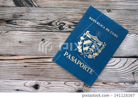 Cuban passport on table close up. Official identification document book for citizens of Cuba. Concept of travel and tourism in Cuba Cuban passport on table close up. Official identification document book for citizens of Cuba. Concept of travel and tourism in Cuba 141128167