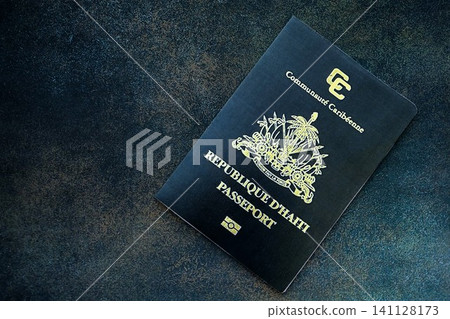 Haitian passport on table close up. Official identification document book for citizens of Haiti. Concept of travel and tourism in Haiti Haitian passport on table close up. Official identification document book for citizens of Haiti. Concept of travel and tourism in Haiti 141128173