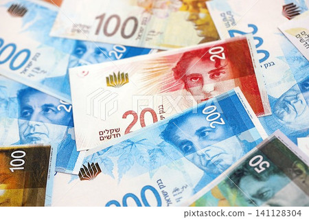 Israel New Shekels banknotes. The current Israel money bills lies on table in big amount Israel New Shekels banknotes. The current Israel money bills lies on table in big amount 141128304