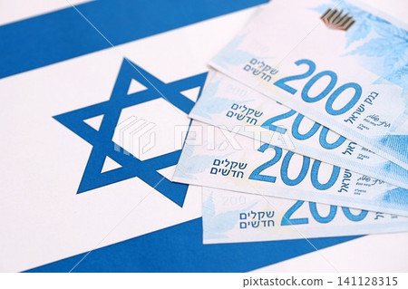 Israel New Shekels banknotes on national flag. The current Israel money bills lies on flag 141128315