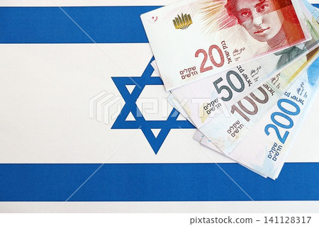 Israel New Shekels banknotes on national flag. The current Israel money bills lies on flag Israel New Shekels banknotes on national flag. The current Israel money bills lies on flag 141128317