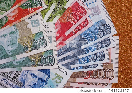 Pakistan rupees banknotes on golden yellow background. The current Pakistan money bills Pakistan rupees banknotes on golden yellow background. The current Pakistan money bills 141128337