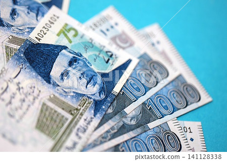 Pakistan rupees banknotes on blue background. The current Pakistan money bills Pakistan rupees banknotes on blue background. The current Pakistan money bills 141128338