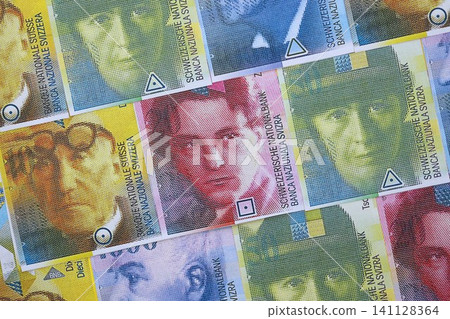 Swiss franc banknotes. The current francs money bills lies on table in big amount close up Swiss franc banknotes. The current francs money bills lies on table in big amount close up 141128364