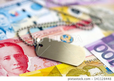 Philippines peso currency money bills and military token. The concept of army service Philippines peso currency money bills and military token. The concept of army service 141128448