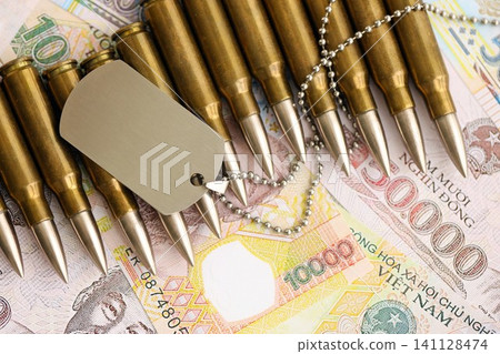 Vietnamese dong currency money bills and rifle bullets with dogtag. The concept of warfare and army service 141128474
