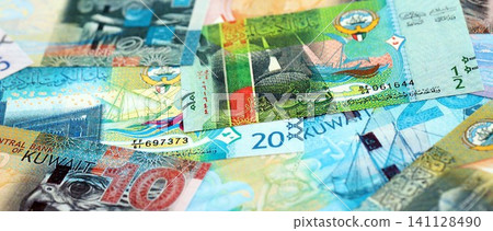 Kuwaiti dinar currency money bills. The current banknotes lies on table in big amount Kuwaiti dinar currency money bills. The current banknotes lies on table in big amount 141128490