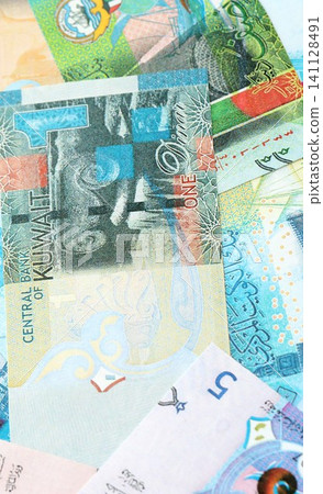 Kuwaiti dinar currency money bills. The current banknotes lies on table in big amount Kuwaiti dinar currency money bills. The current banknotes lies on table in big amount 141128491