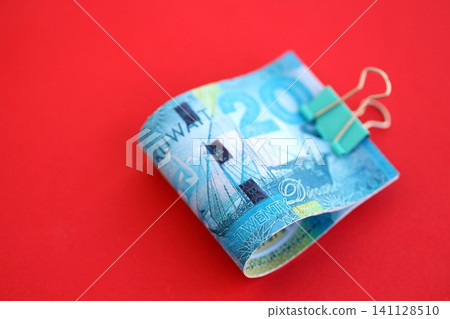 Kuwaiti dinar money bills in big amount on red. Finance and banking concept Kuwaiti dinar money bills in big amount on red. Finance and banking concept 141128510