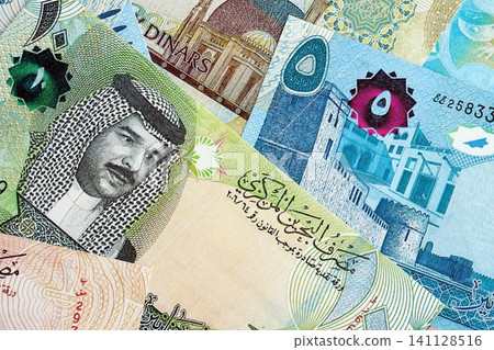 Bahraini dinar currency money bills. The current banknotes lies on table in big amount Bahraini dinar currency money bills. The current banknotes lies on table in big amount 141128516