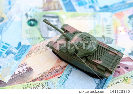 Bahraini dinar currency money bills and toy tank. The concept of army funds and weapons sales Bahraini dinar currency money bills and toy tank. The concept of army funds and weapons sales 141128520